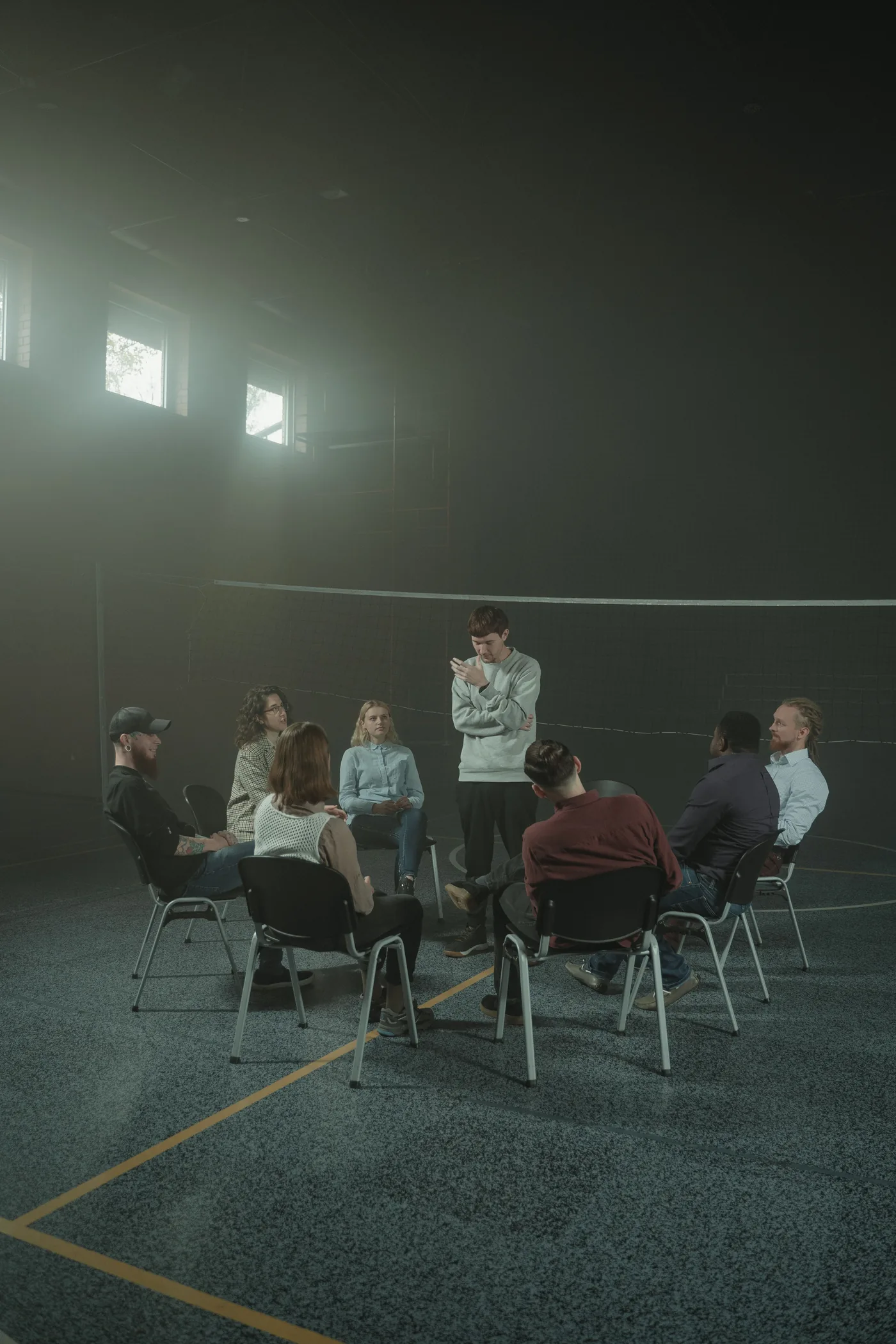 A peer support group sitting in a circle and listening to one another